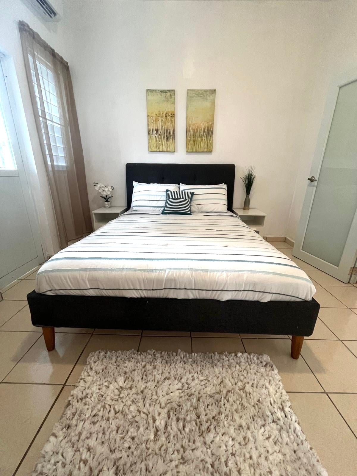 Bright guest bedroom with striped bedding