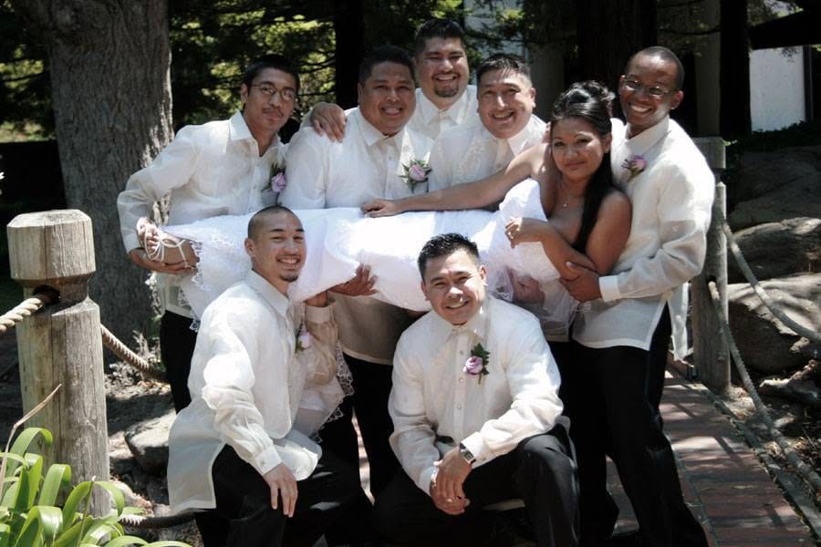 The wedding party carrying the bride
